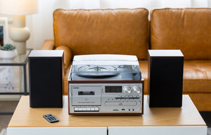 Brown Wood-pattern Audio Home Entertainment System on a table in a living room with the remote next to it.