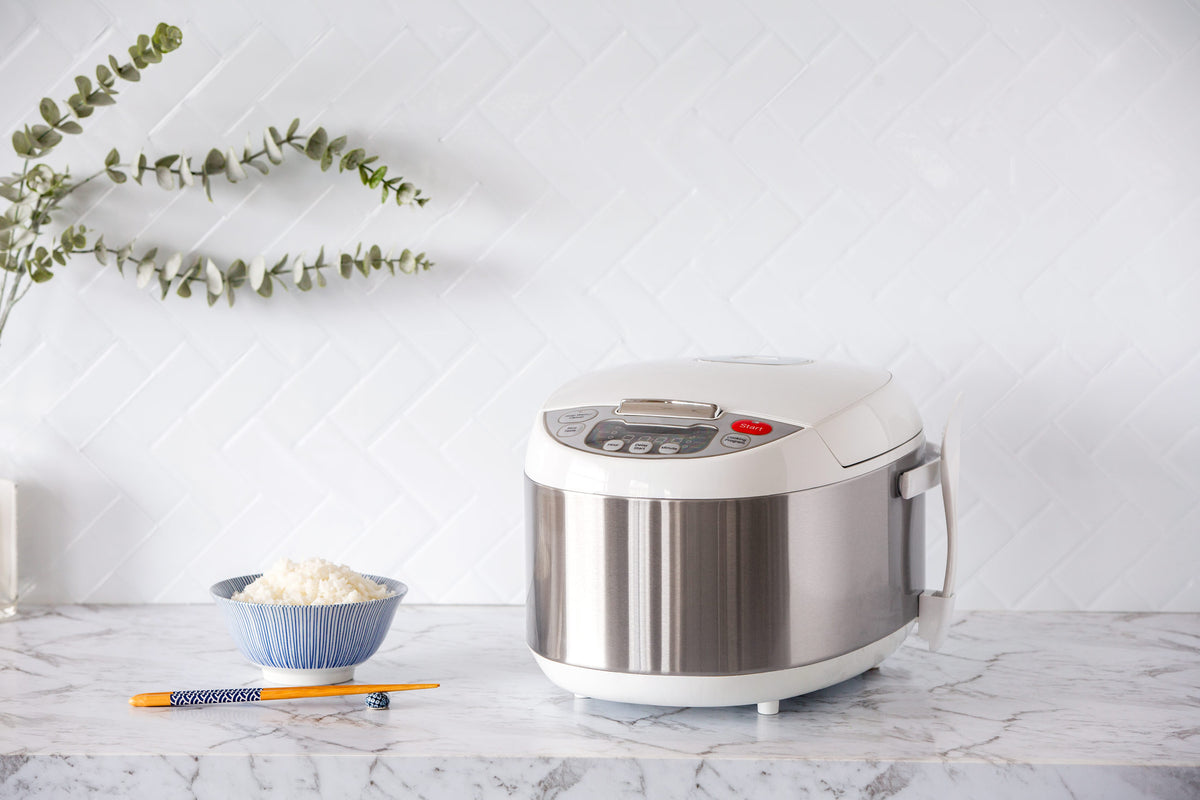 5L Electric Rice Cooker and a bowl of fluffy cooked rice next to it on a kitchen benchtop.