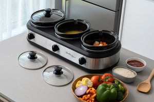 3-Pot Slow Cooker with vegetables, rice and soup cooking in a modern kitchen.