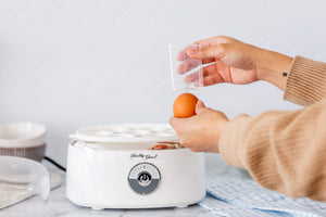 Using the egg piercer at the bottom of the measuring cup.