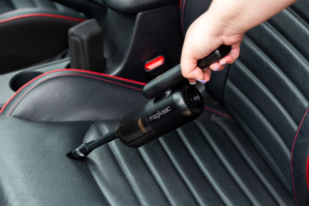Mini Cordless USB-C Rechargeable Car Vacuum Cleaner cleaning a black car seat.
