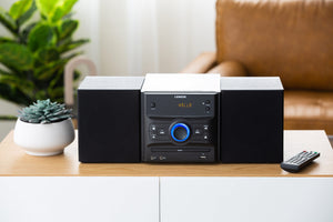 Bluetooth DVD Hi-Fi Speaker Sound System in a modern living room setting with the remote controller next to it.