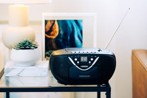 CD815 with the antenna extended on a side table in a cosy living room.
