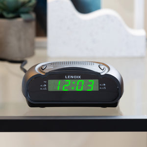 Black rounded AM/FM Alarm Clock & Radio with Large Green LED Time Numbering on a glass table.
