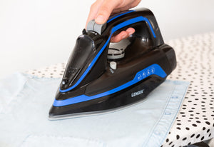 Close up of the Cordless Steam Iron being used in a laundry room.