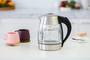 1.7 Litre Glass Kettle next to two mugs in a kitchen setting.