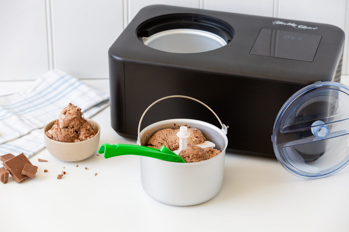 Black ice cream maker with a container of ice cream on a white surface