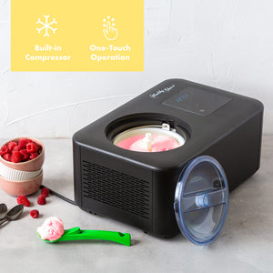 Black ice cream maker with built-in compressor and one-touch operation on a light gray surface.