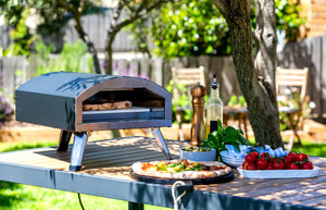 Healthy Choice 12" Outdoor Electric Pizza Oven with an Australian backyard in the background.