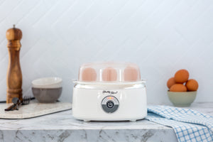 Electric Egg Steamer in a modern kitchen with eggs cooking inside.