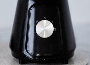 Close up of the chrome knob of the black table blender.