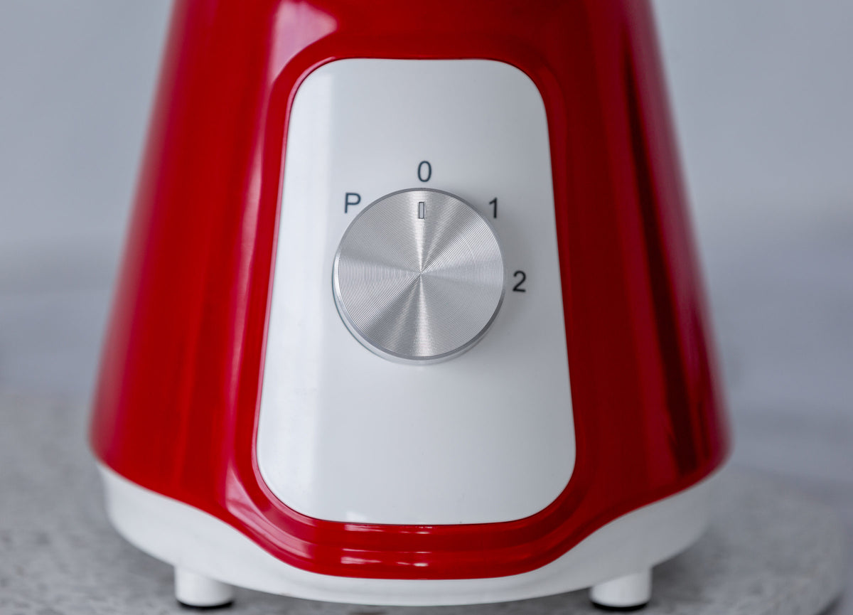 Close up of the chrome knob of the red table blender.