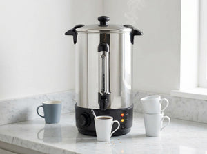 Stainless steel water urn on a marble benchtop with white cups.