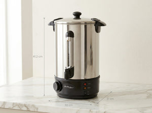 Stainless steel urn with dimensions displayed on a marble surface