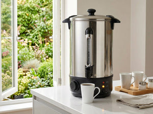 Stainless steel water urn on a kitchen banchtop with a garden view