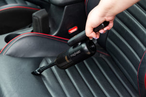 Mini Cordless USB-C Rechargeable Car Vacuum Cleaner cleaning a black car seat.
