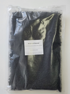 Activated charcoal filter refill in a clear package.