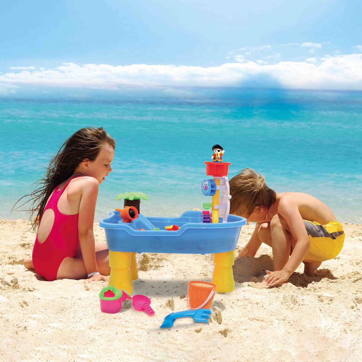 Kids playing with the Children's Pirate Theme Ship Sand & Water Table at a beach.