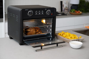 AFO238 Black 23L Air Fryer Oven in a modern kitchen. The door is open and a whole cooked chicken is inside the air fryer.