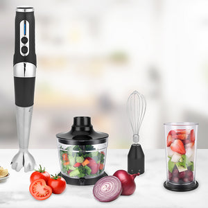 Sleek black & silver cordless stick hand blender with attachments - fruit in the cup and salad ready for blending.