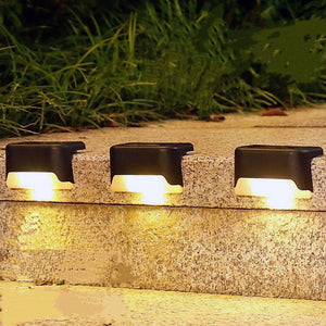 Solar deck lights installed on an outdoor step.