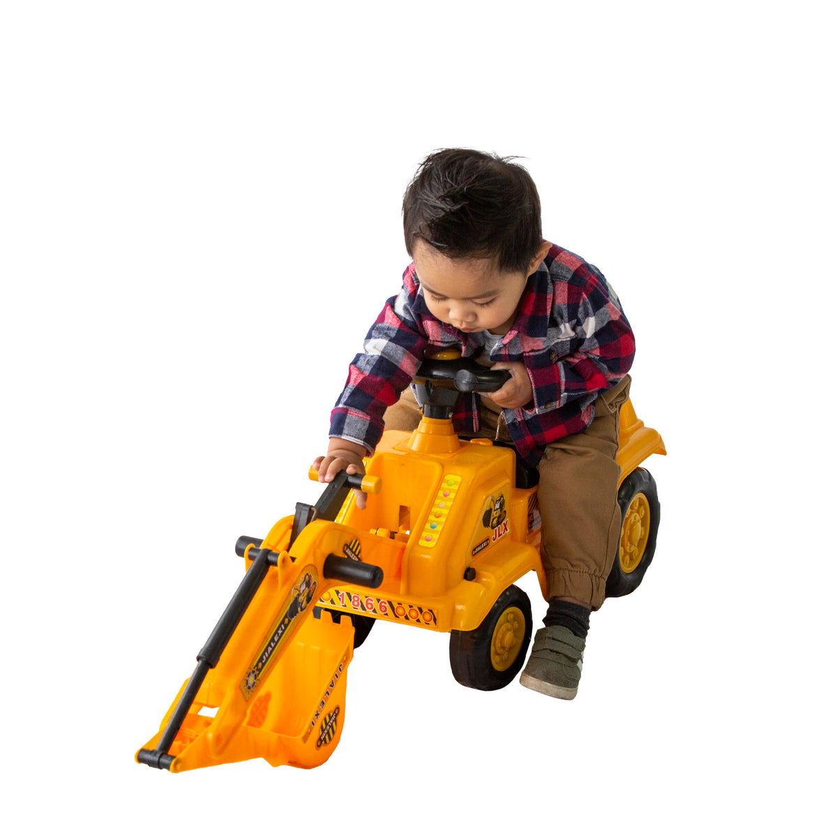 Little boy playing with the yellow ride-on toy excavator.